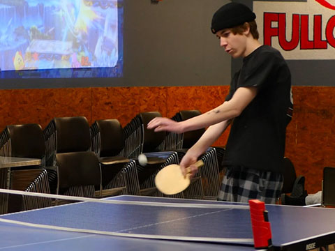 A sober young person playing ping pong in the FullCircle Program's Arizona coffee shop.